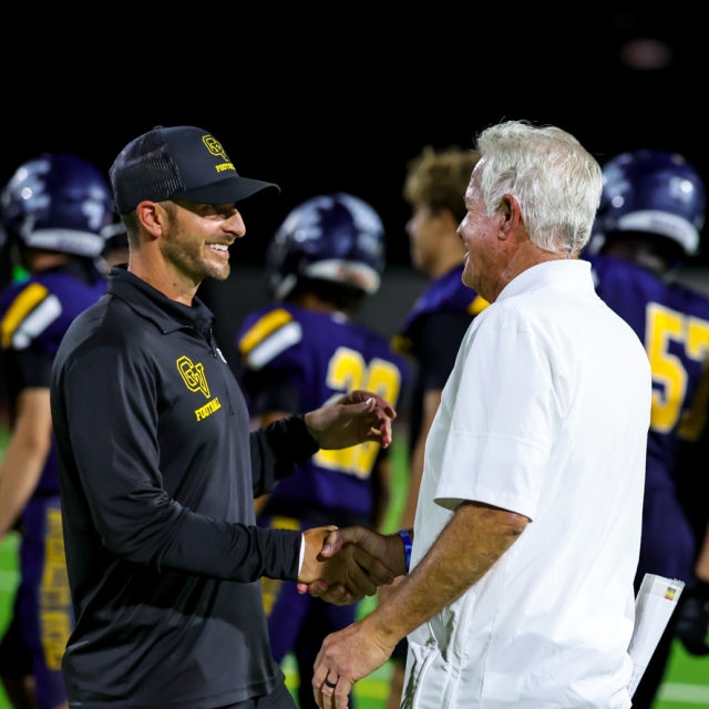 Father and son head coaches sean left and rick curtis meet midfield postgame 640x640 c